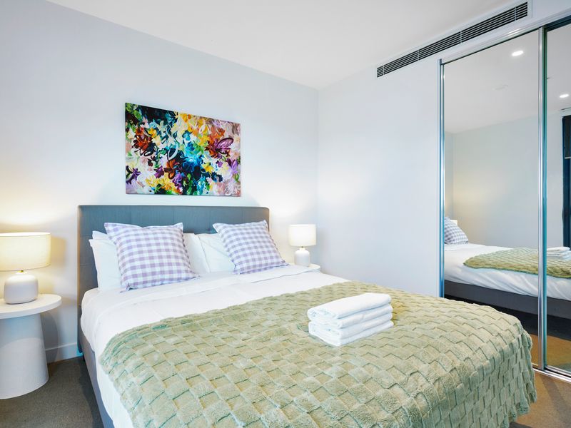 Inviting bedroom with soft linens and a calming atmosphere.