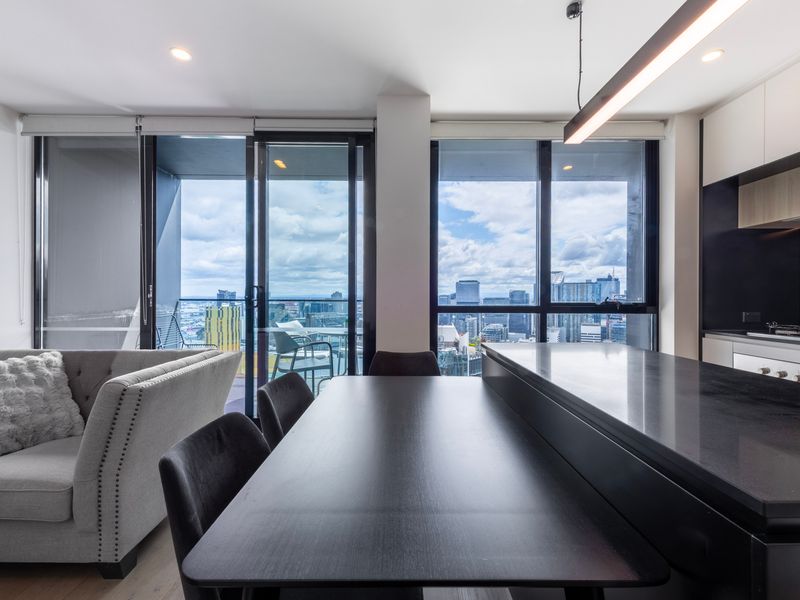 Open dining area seamlessly connected to the balcony and city views