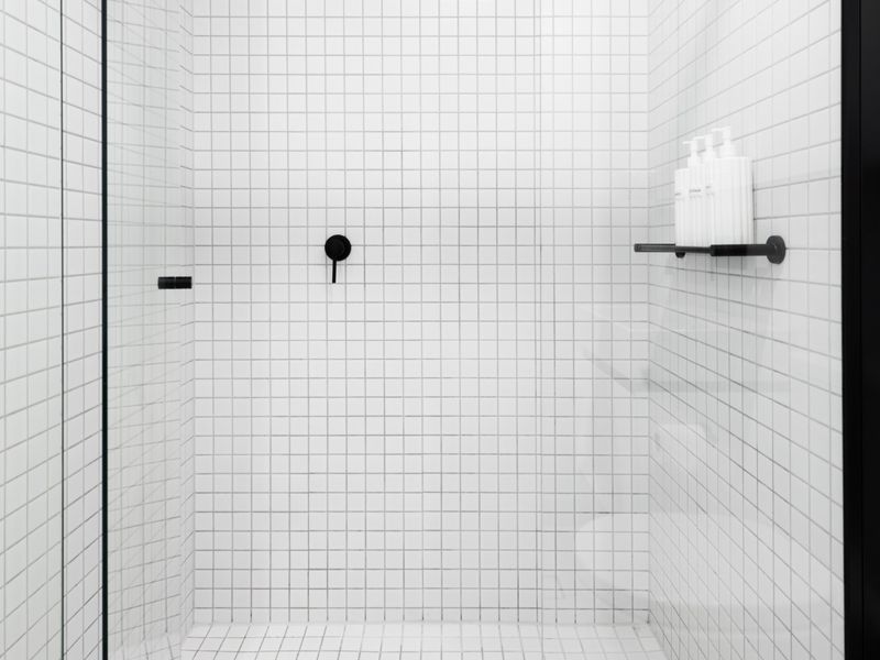 Spacious walk-in shower with chic black accents