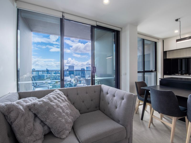 Cozy lounge with floor-to-ceiling windows and skyline backdrop