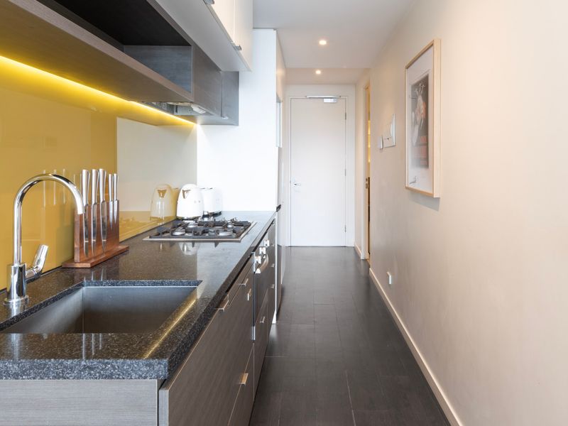 Another angle of the kitchen, showcasing sleek finishes and ample counter space for convenience.