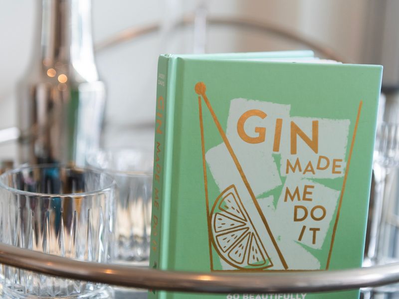 Close-up of a thoughtfully placed book and fresh drink, adding a personal touch to your stay.