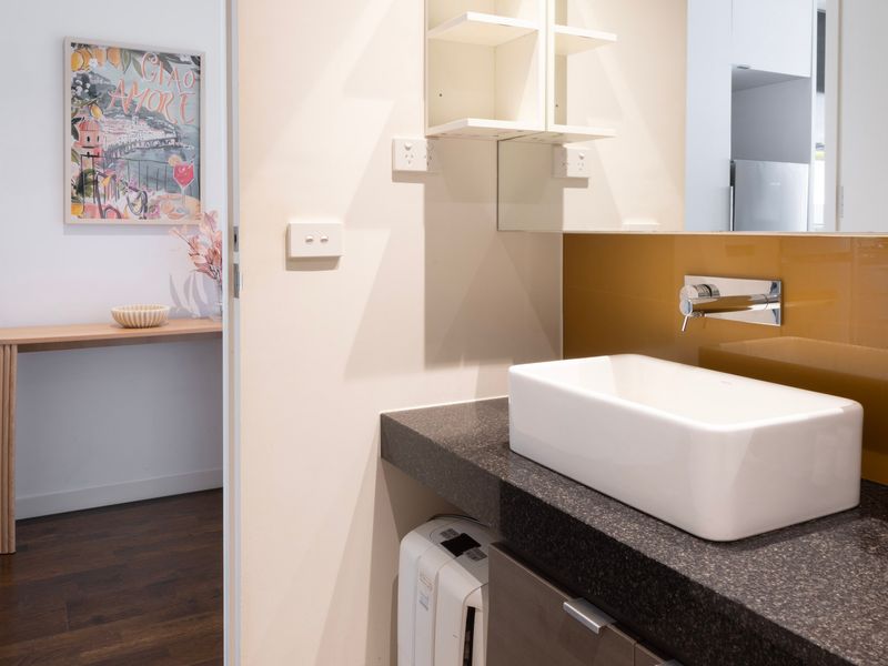 Stylish bathroom sink area with minimalist design and beautiful lighting, creating a tranquil atmosphere.