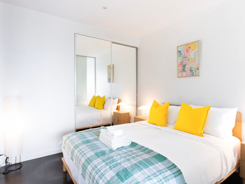 Relax in comfort with a stylish bedroom featuring a comfy bed and colorful accents.