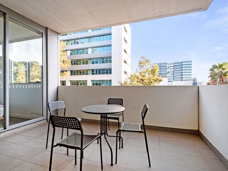 Private balcony with outdoor seating and leafy outlook.