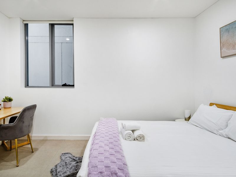 Bedroom with work desk and comfortable chair.