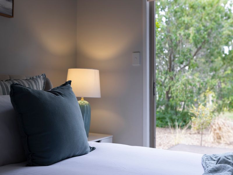 Inviting space with pillows and a calming lamp.