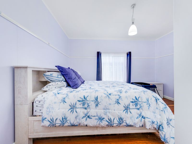 Comfortable bedroom with fresh linens and natural light.