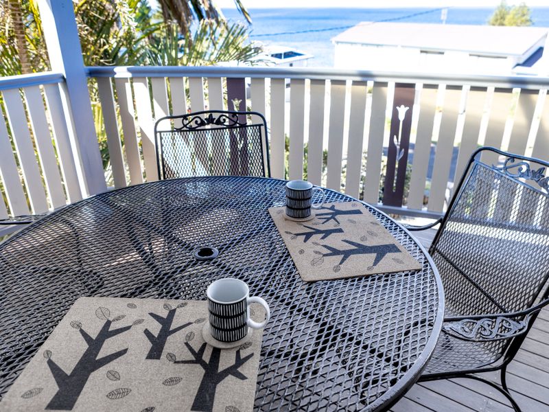 Cozy veranda setting to enjoy coffee with a view.