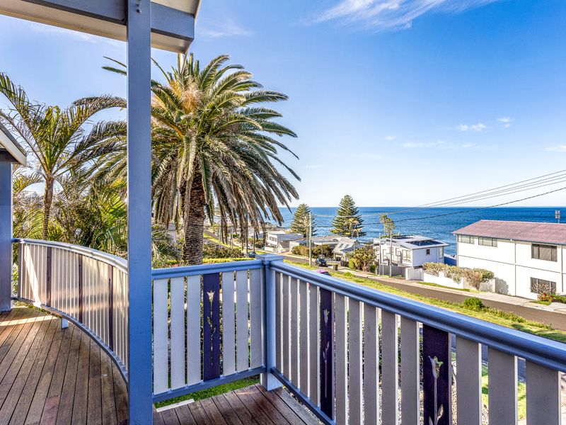 Relax on the balcony and enjoy sweeping ocean views framed by palm trees.