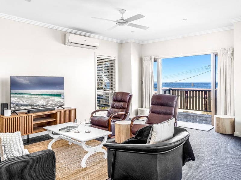 Light-filled living space designed for comfort and relaxation, perfect for gathering after a day at the beach