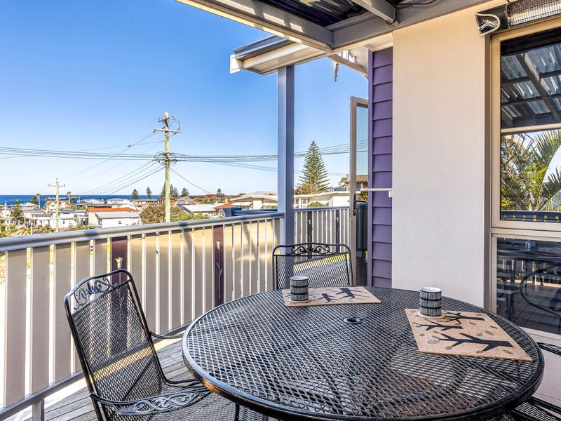 Veranda with table, perfect for morning coffee with ocean views.