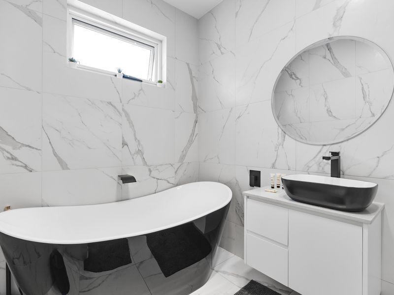 Unwind in the sleek bathtub retreat.