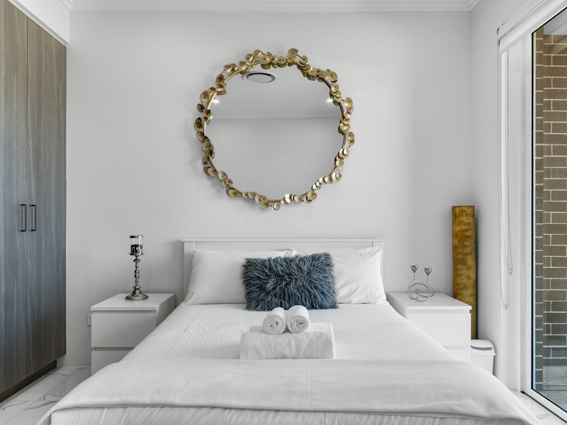 Neatly presented bedroom with warm tones.