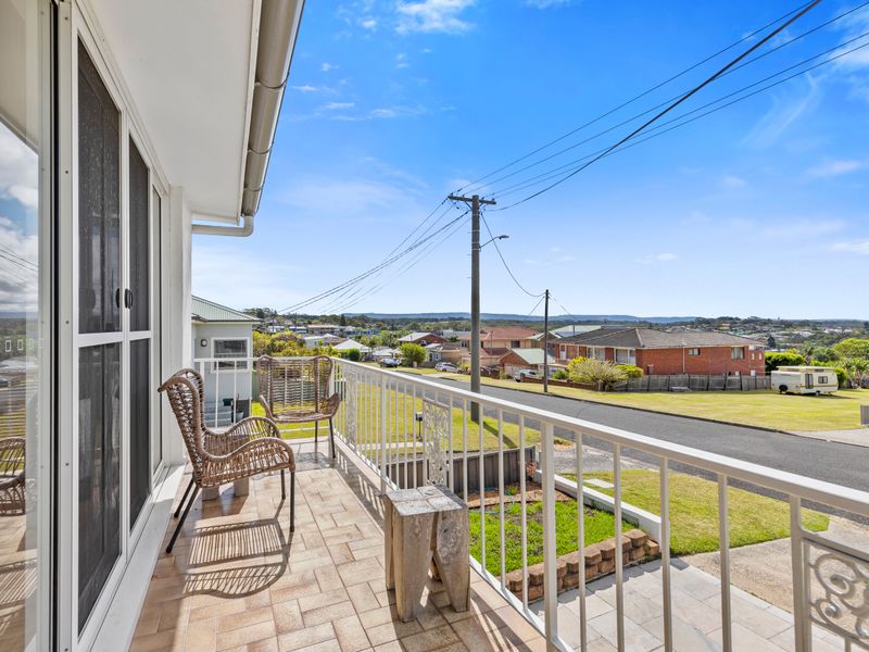 Balcony nook with outdoor chairs and views of the neighborhood