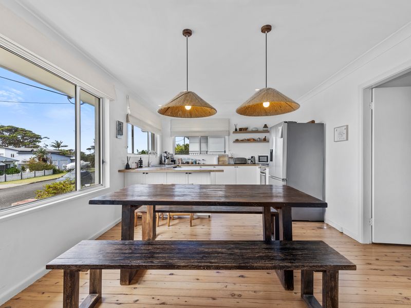 Dining nook with large windows and sunny views