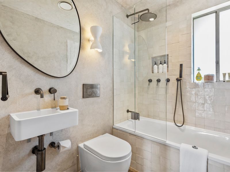 Stylish bathroom with bathtub, rainfall shower, and modern design