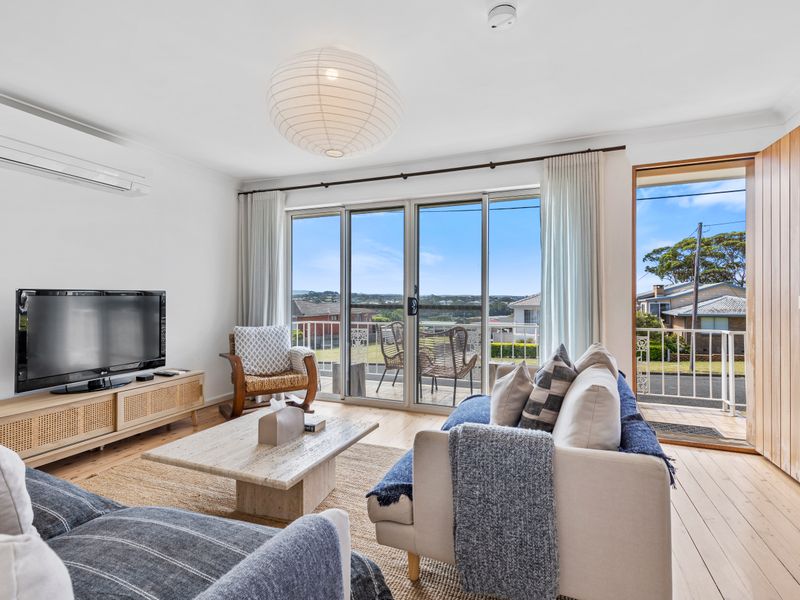 Bright and welcoming living area with comfy seating and smart TV
