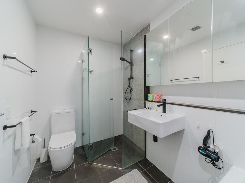 Bathroom with separate shower and sleek finishes.