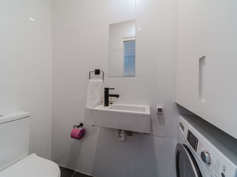 Powder room with toilet and laundry facilities.