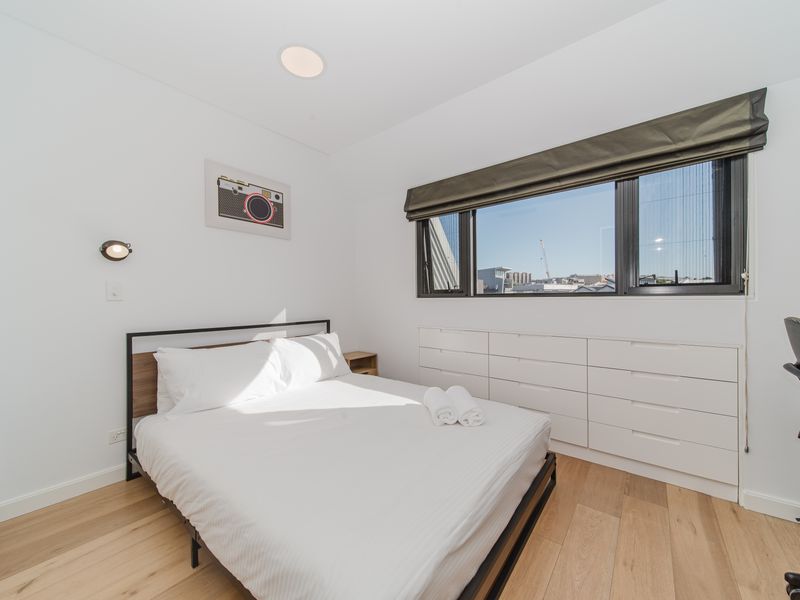 Bright bedroom with a comfy bed and natural light.