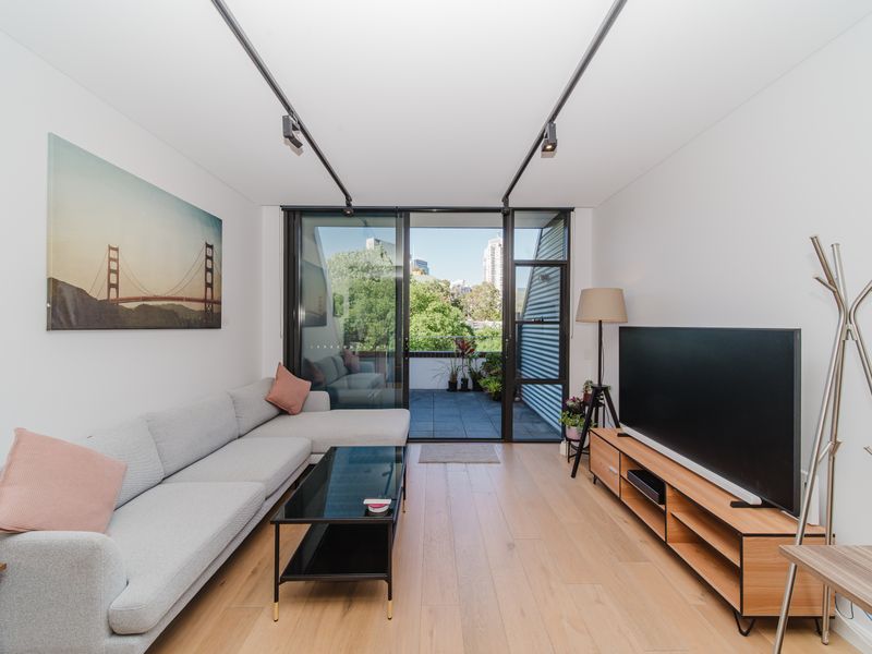 Living area with sofa and balcony access.