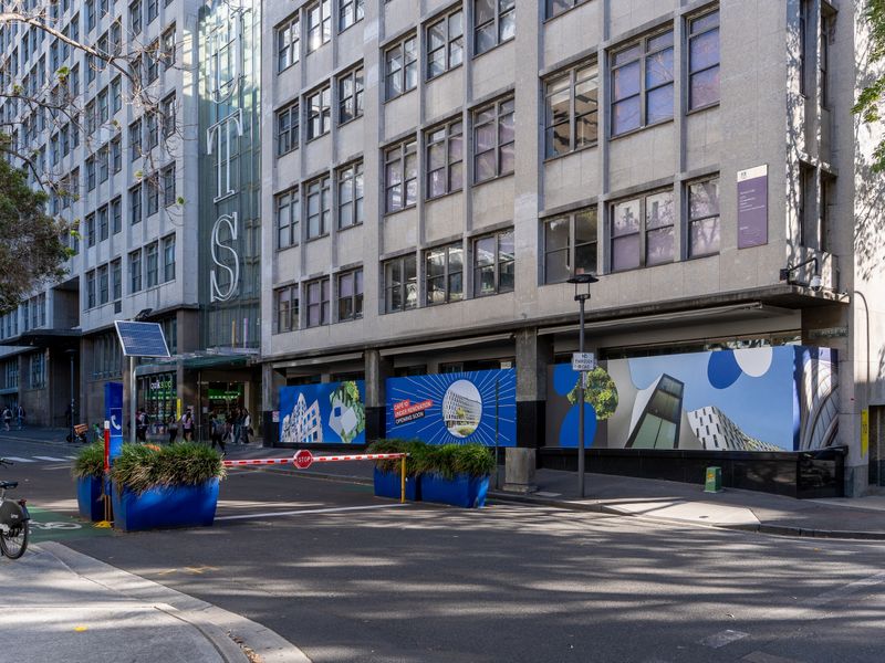 City laneway with cafés and street art.