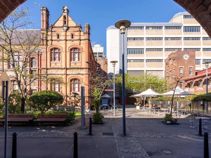 Heritage-style buildings and a public square.