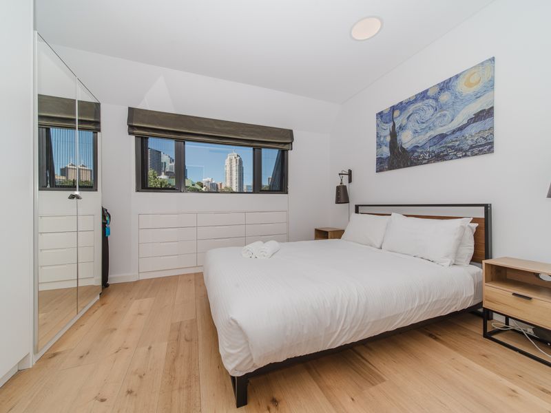 Bedroom with cozy bedding and natural light.