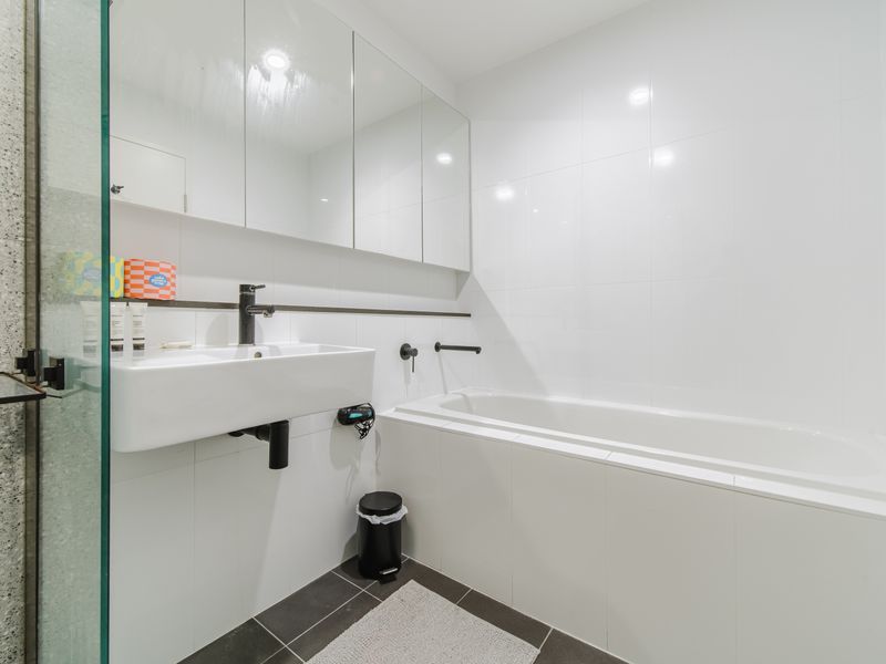 Bathroom with bathtub and clean finishes.