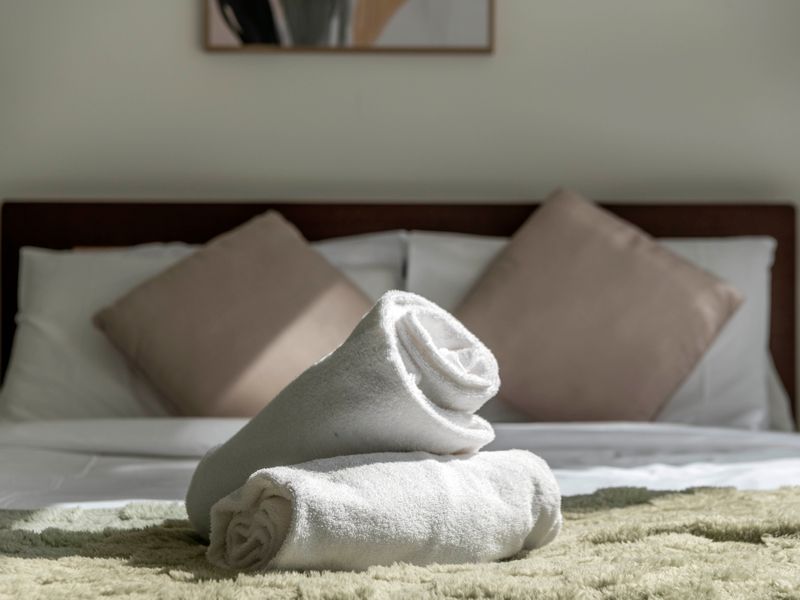 Queen bed with fresh linen, pillows, and soft furnishings