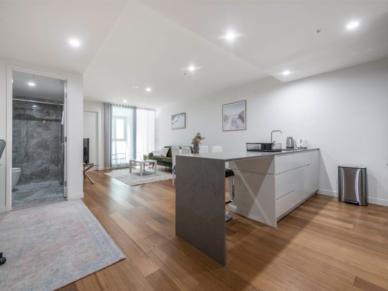 Hallway and kitchen view showcasing spacious apartment layout