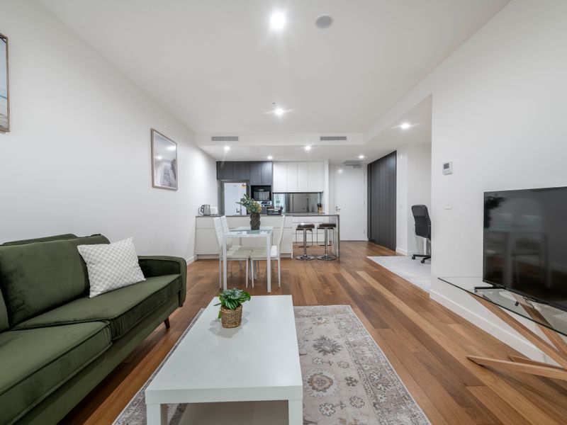 Bright lounge with comfortable seating and large flat-screen TV