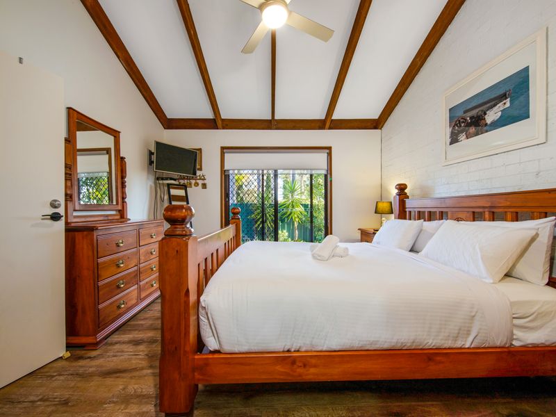 Well-appointed bedroom with soft furnishings and natural light.