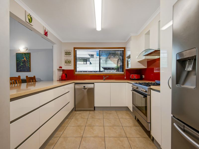 Open-plan kitchen with bar seating, designed for both cooking and entertaining.