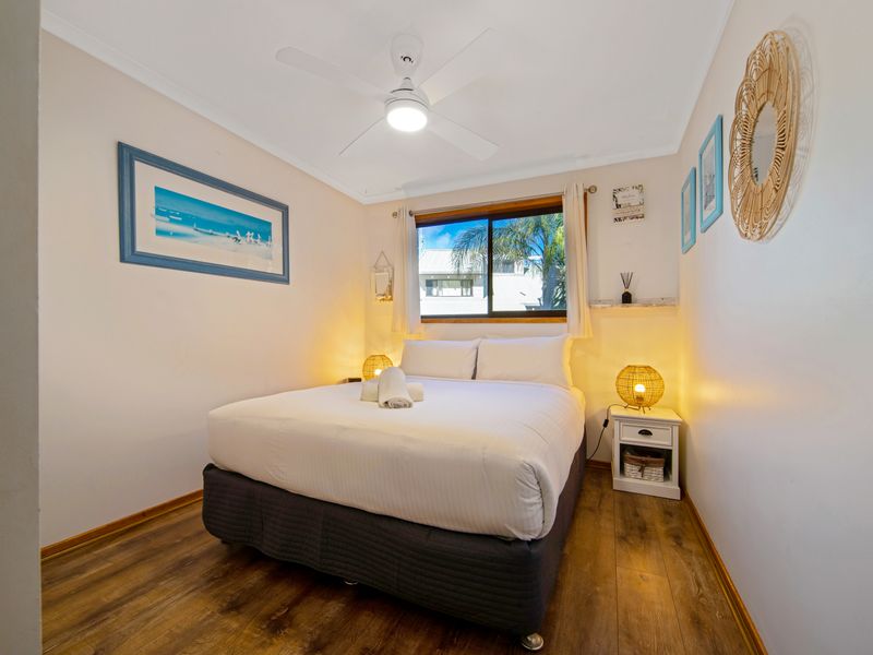 Cozy bedroom with soft lighting and a relaxing ambiance.