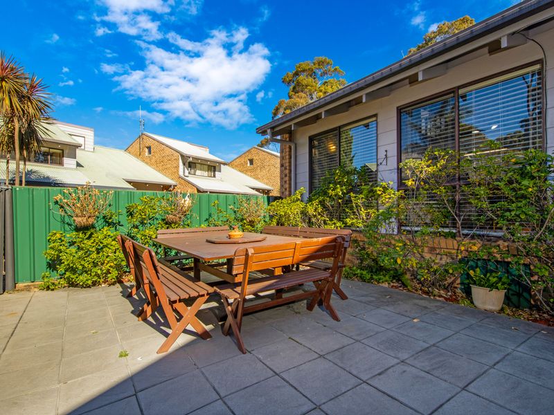 Relax and dine outdoors with a comfortable table setting.