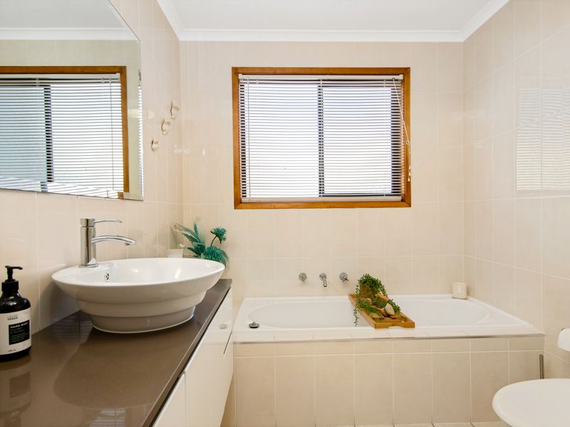 Unwind in the sleek bathroom with both shower and bathtub options.
