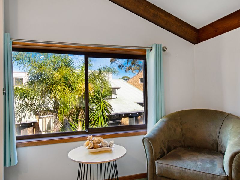 Inviting nook with a large window framing leafy views.