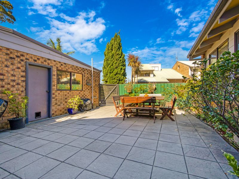 Spacious alfresco dining setup, ideal for gatherings and entertaining.