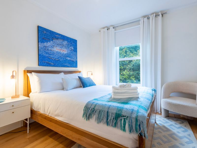 Main bedroom with queen bed and soft linens