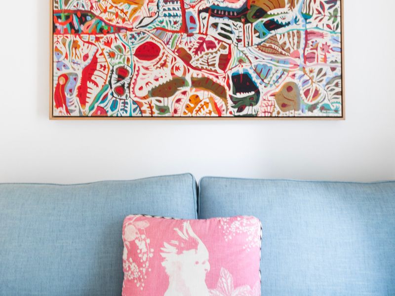 Cozy sofa with colourful artwork