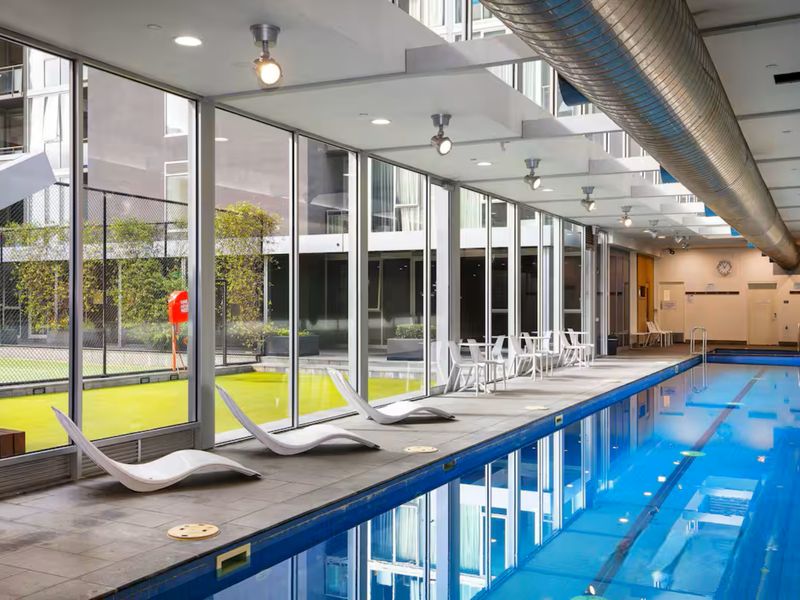 Enjoy a refreshing dip in the sleek indoor pool with lounge seating.