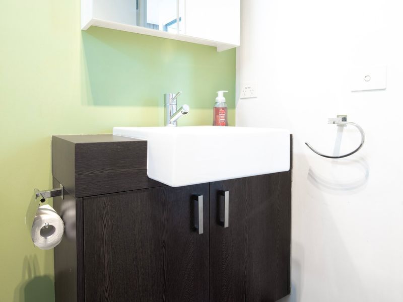 Convenient laundry sink and storage for longer stays.