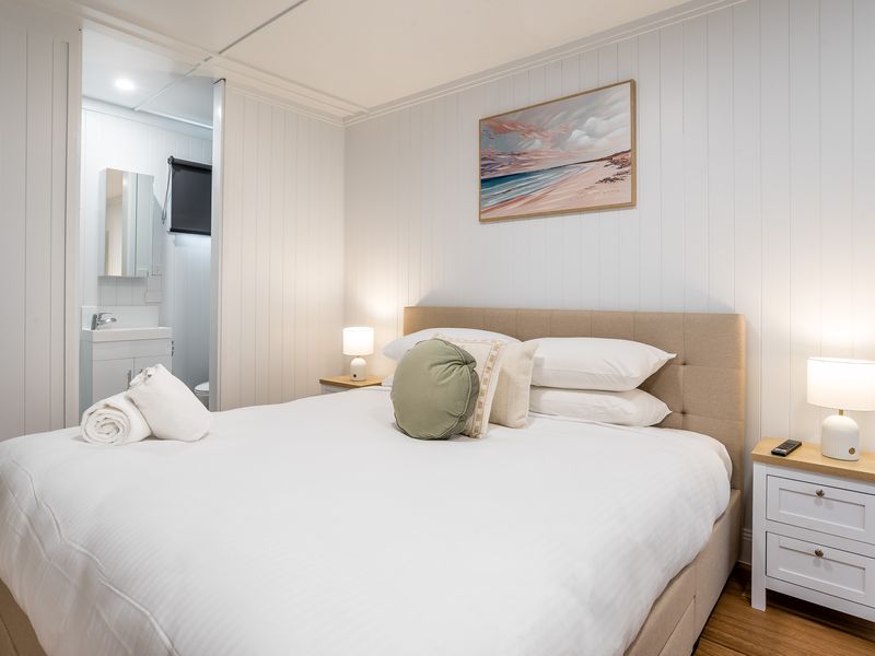 Comfortable guest bedroom with queen bed and soft lighting