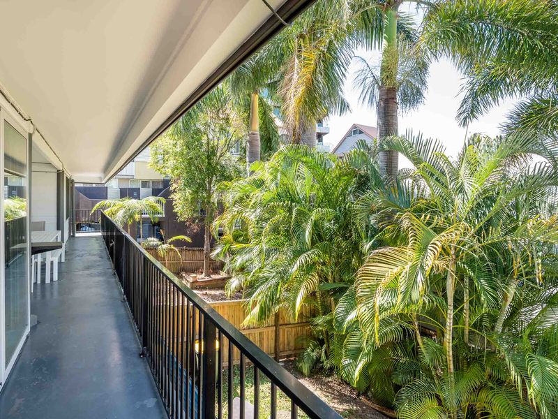 Balcony walkway overlooking lush tropical gardens