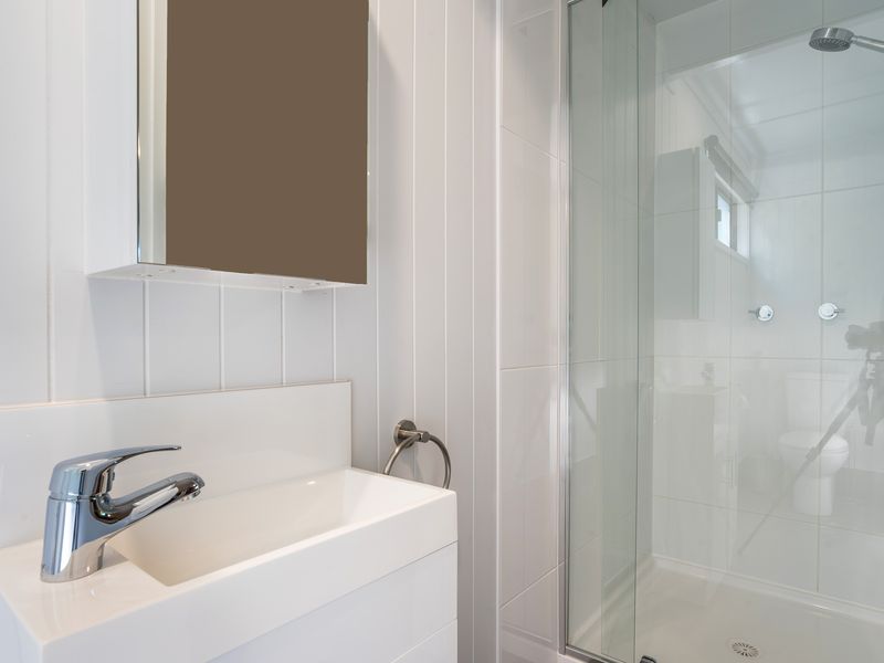 Modern shower with glass enclosure and updated fittings