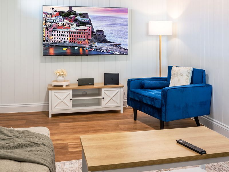 Elegant sitting area with blue accent chair.