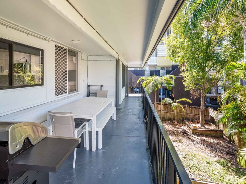 Covered outdoor dining space with table and chairs