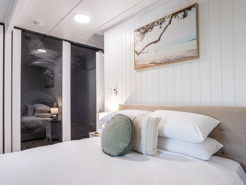 Cozy bedroom with stylish headboard and decorative wall art